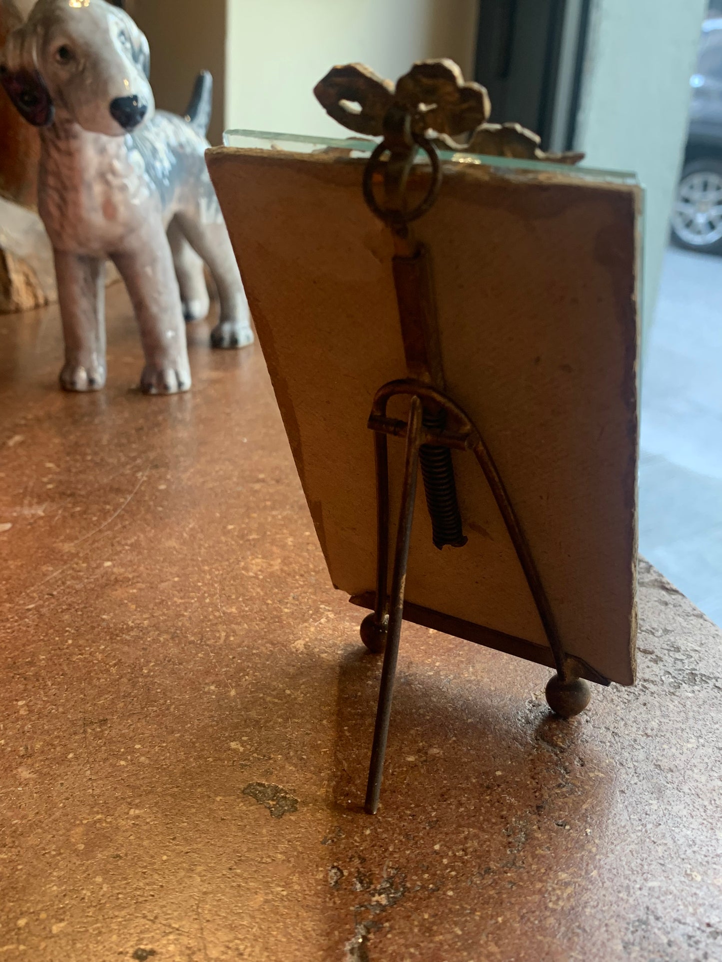 A miniature portrait of an elegant man in a black tie and pleated shirt with jewel buttons, dated 1833.