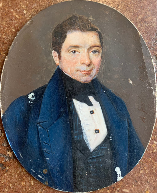 A miniature portrait of an elegant man in a black tie and pleated shirt with jewel buttons, dated 1833.