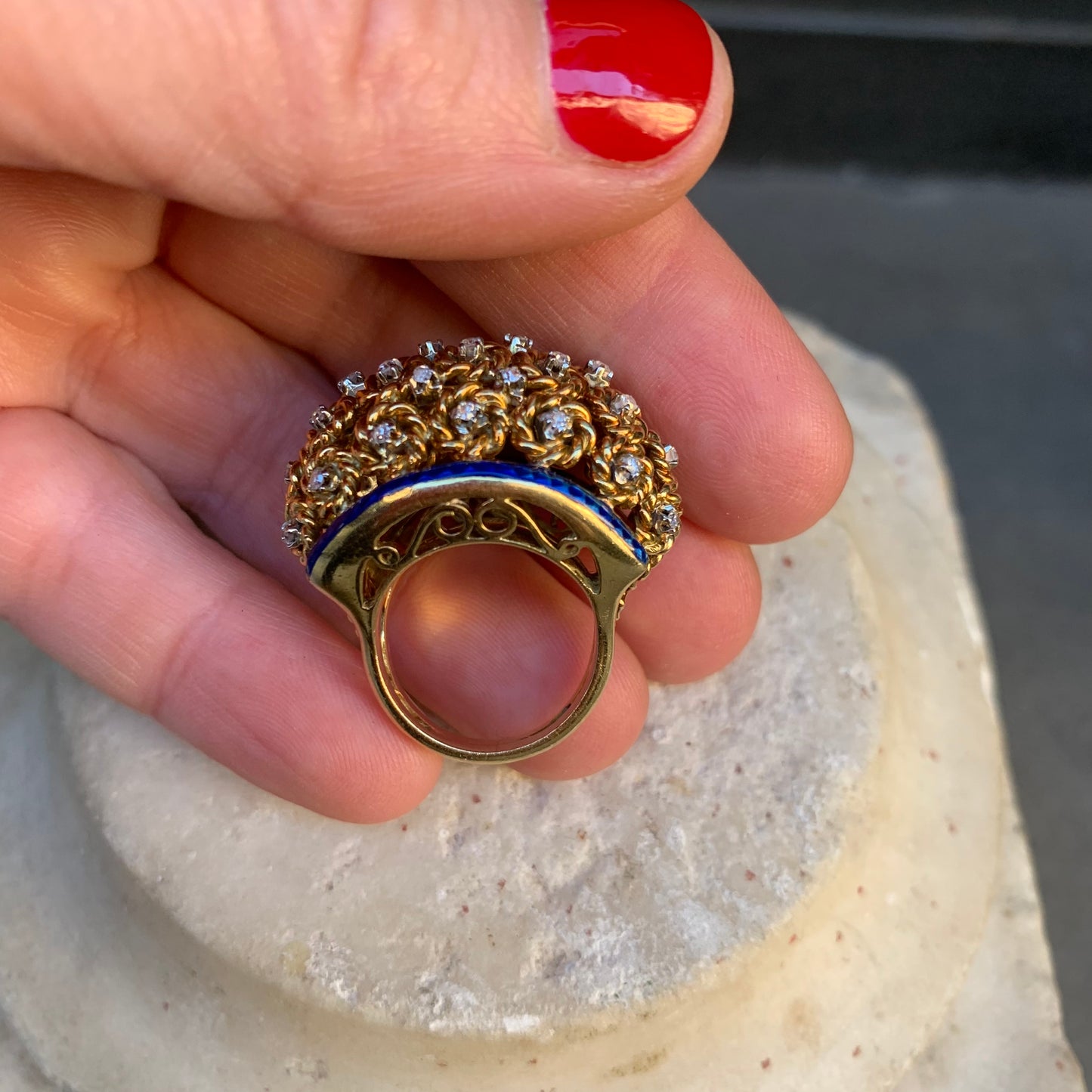 A dome ring with brilliant flowers and blue enamel.