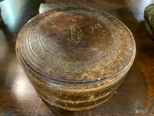Round embossed leather box.