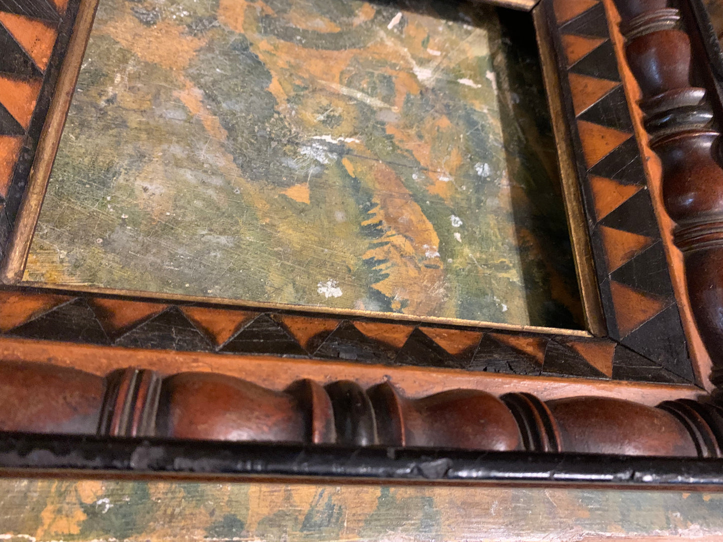 Unusual frame in various woods with geometric decorations. Early 19 century