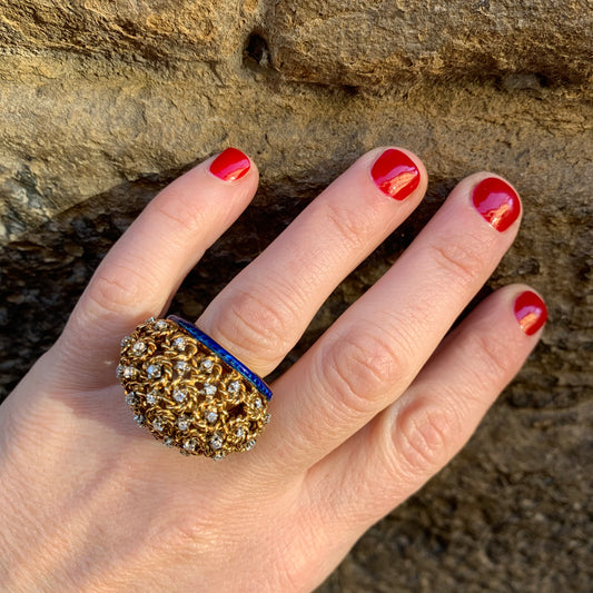 A dome ring with brilliant flowers and blue enamel.