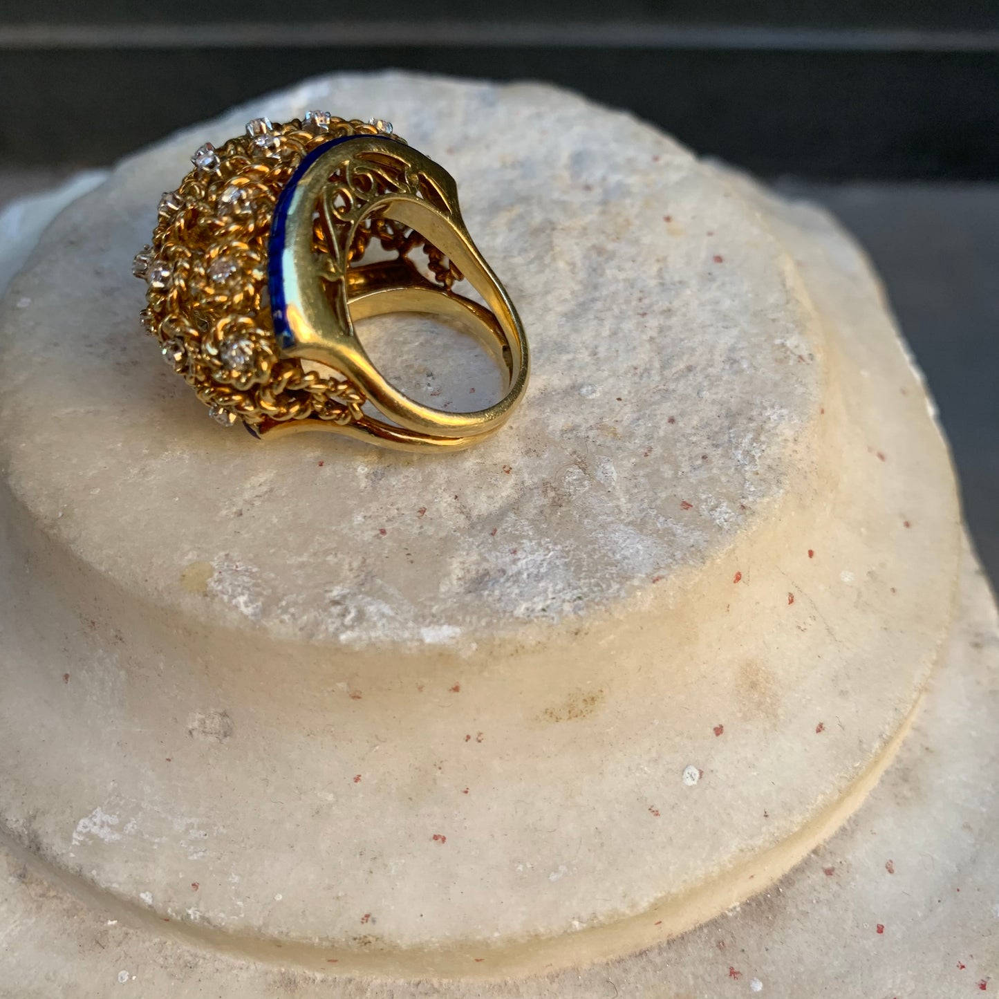 A dome ring with brilliant flowers and blue enamel.