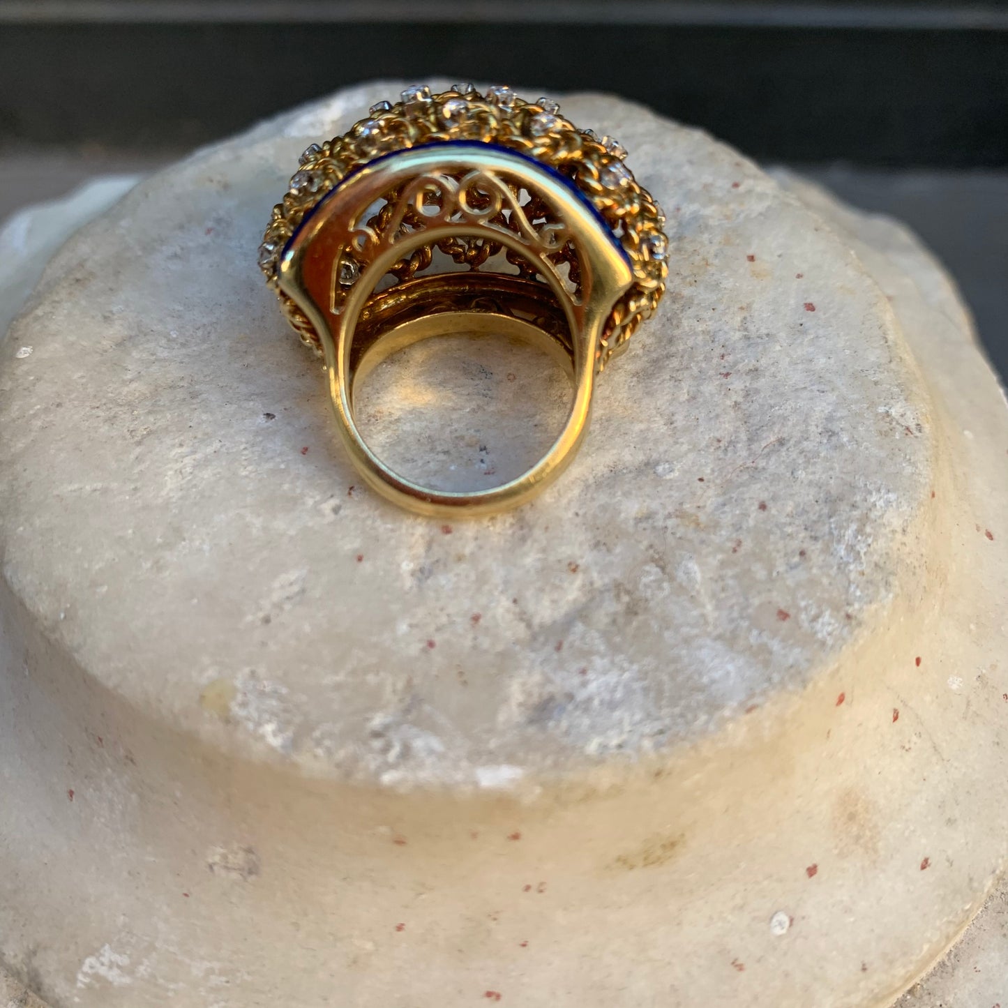 A dome ring with brilliant flowers and blue enamel.