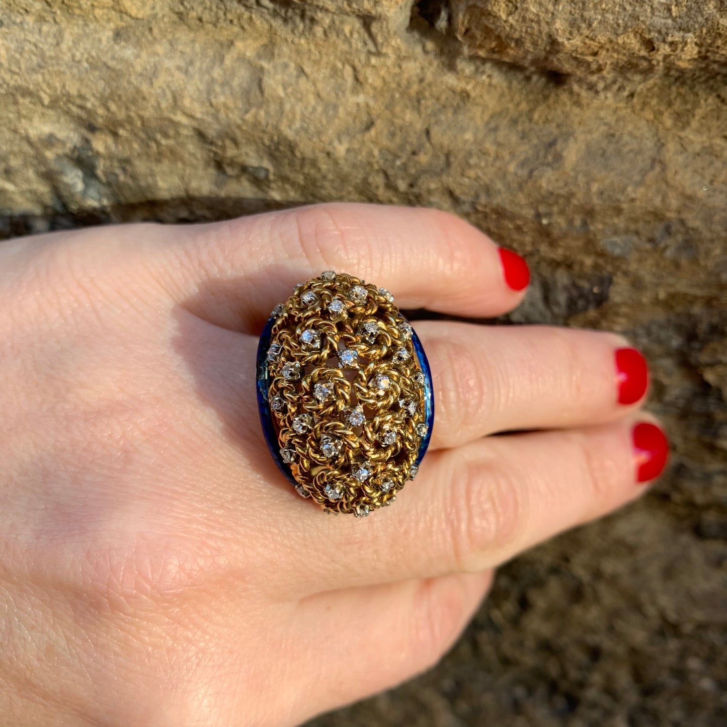 A dome ring with brilliant flowers and blue enamel.