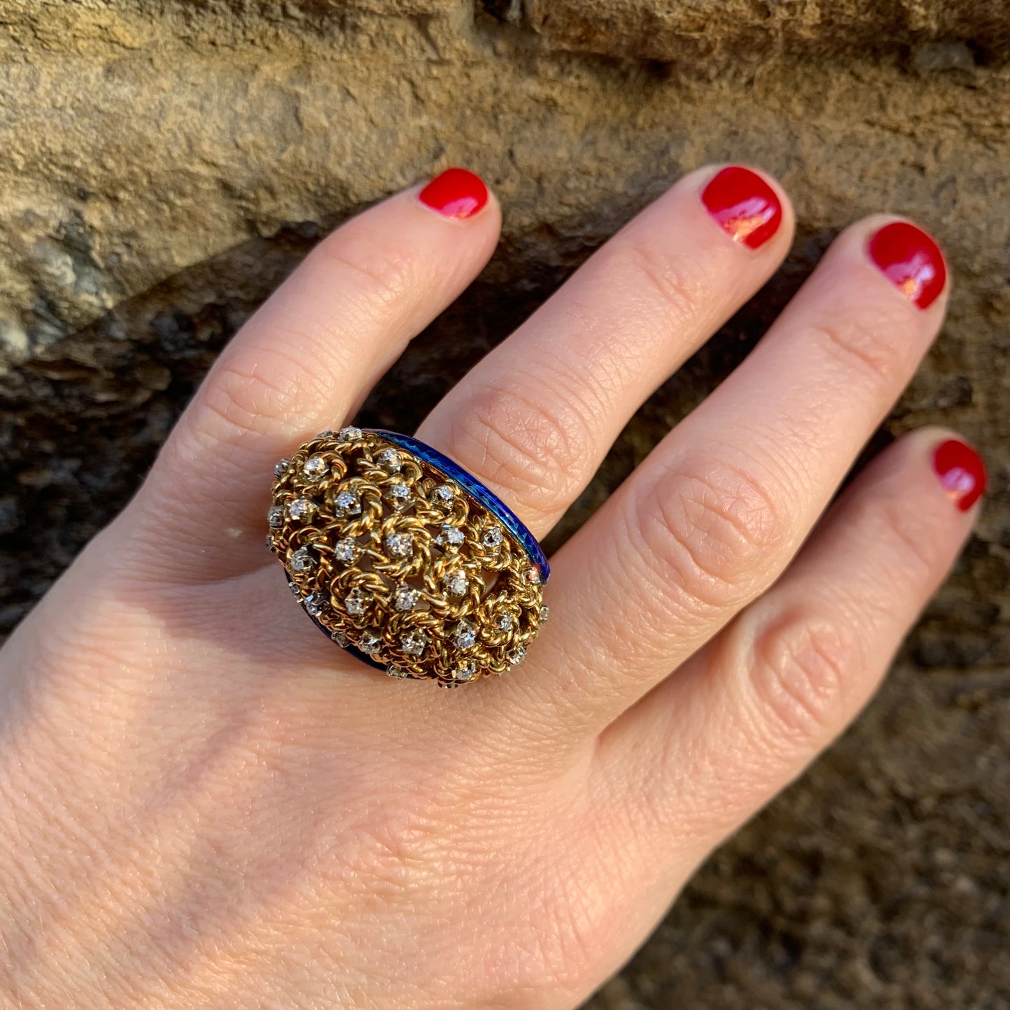 A dome ring with brilliant flowers and blue enamel.