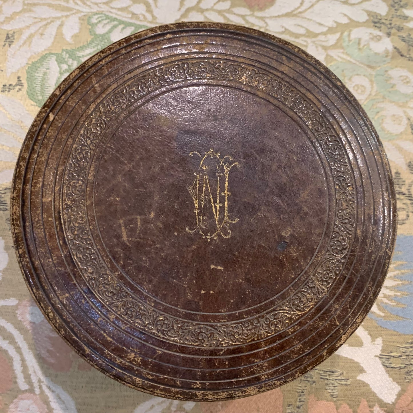 Round embossed leather box.