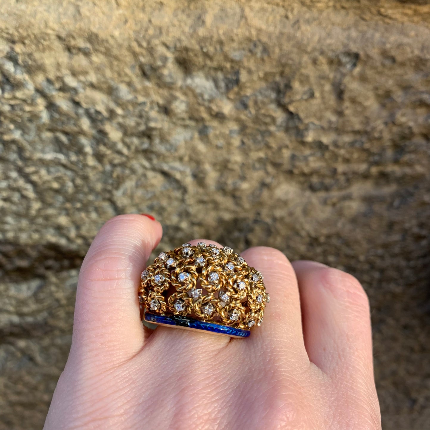 A dome ring with brilliant flowers and blue enamel.