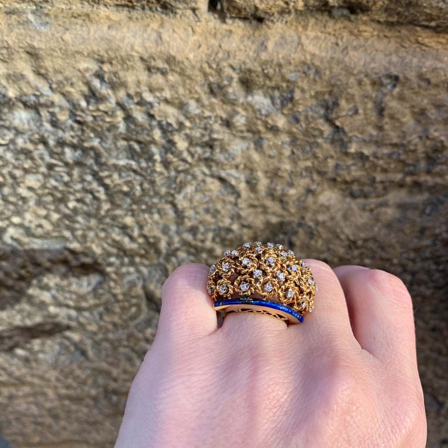 A dome ring with brilliant flowers and blue enamel.