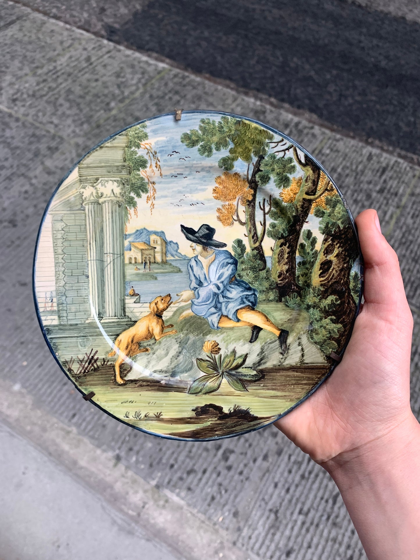 Castelli maiolica dish with young man in black hat, dog and classical ruins, mid-18th century