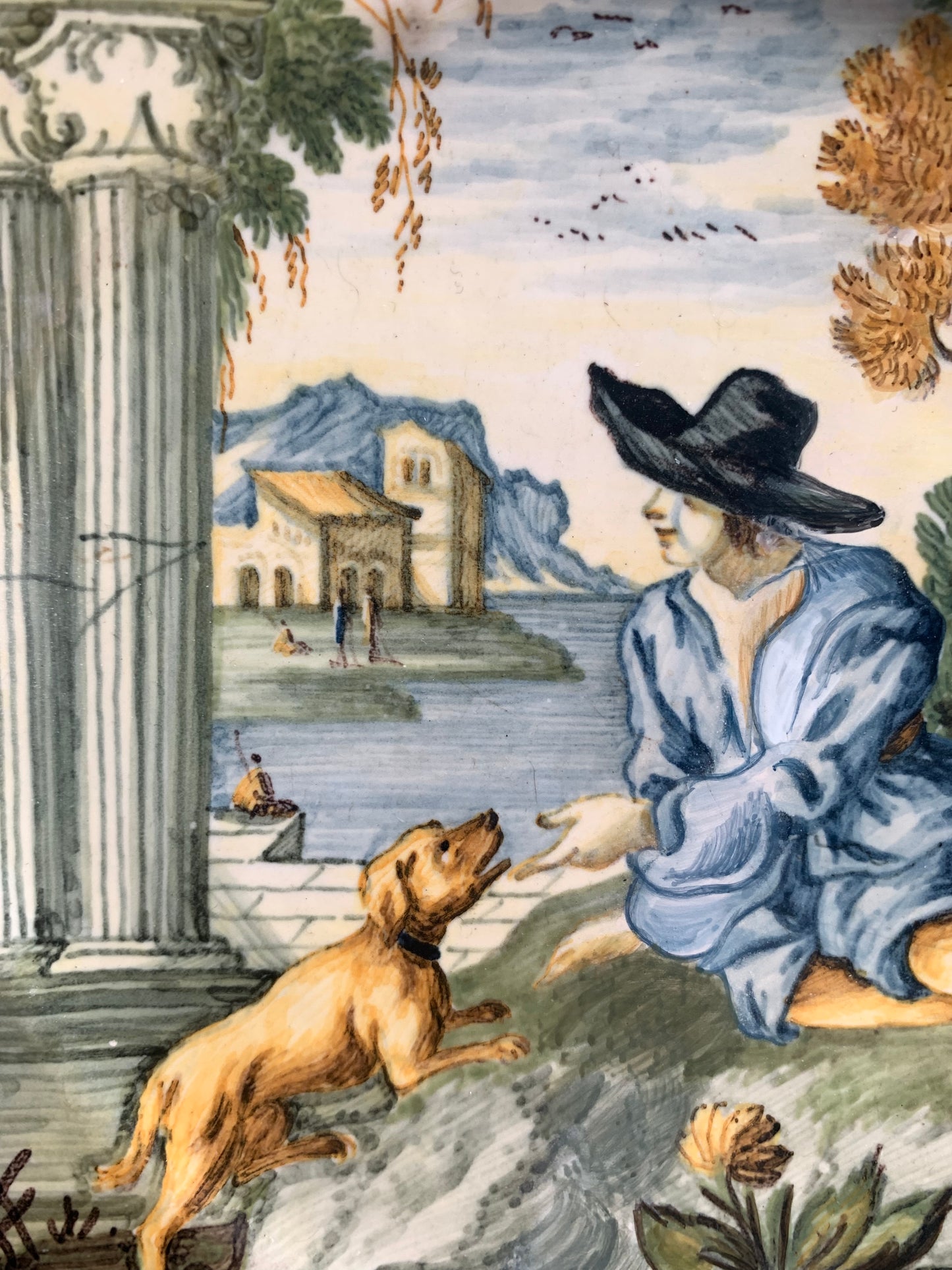Castelli maiolica dish with young man in black hat, dog and classical ruins, mid-18th century