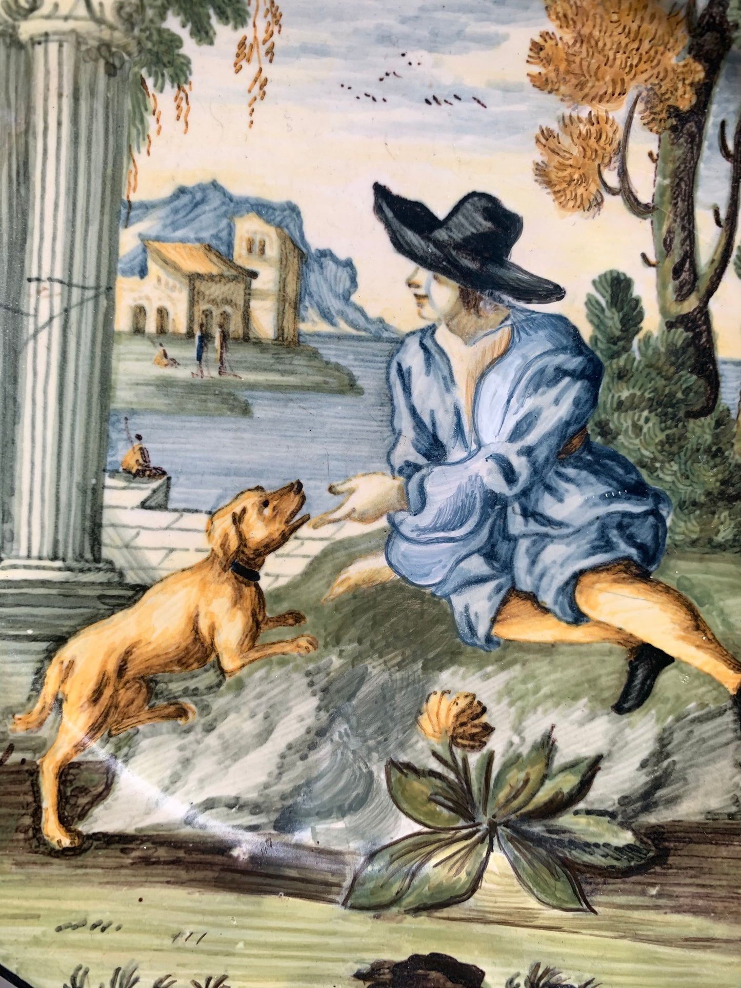 Castelli maiolica dish with young man in black hat, dog and classical ruins, mid-18th century
