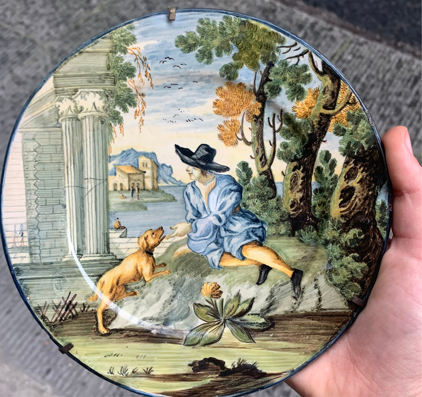 Castelli maiolica dish with young man in black hat, dog and classical ruins, mid-18th century