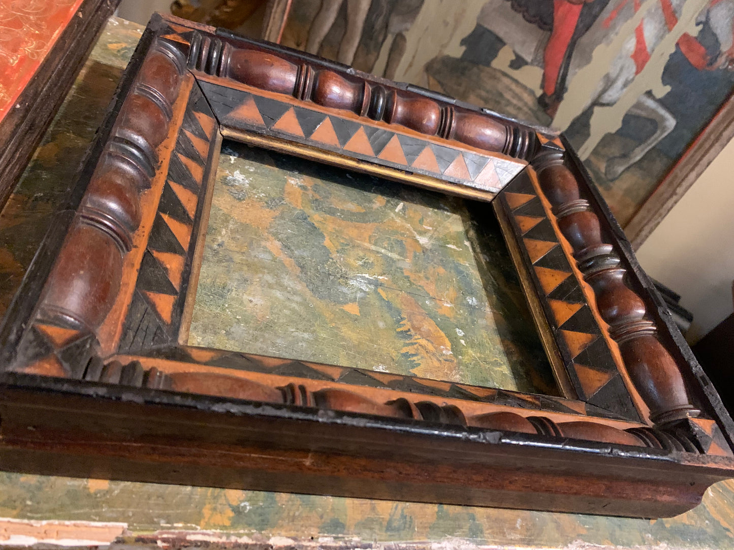 Unusual frame in various woods with geometric decorations.  Early 19 century