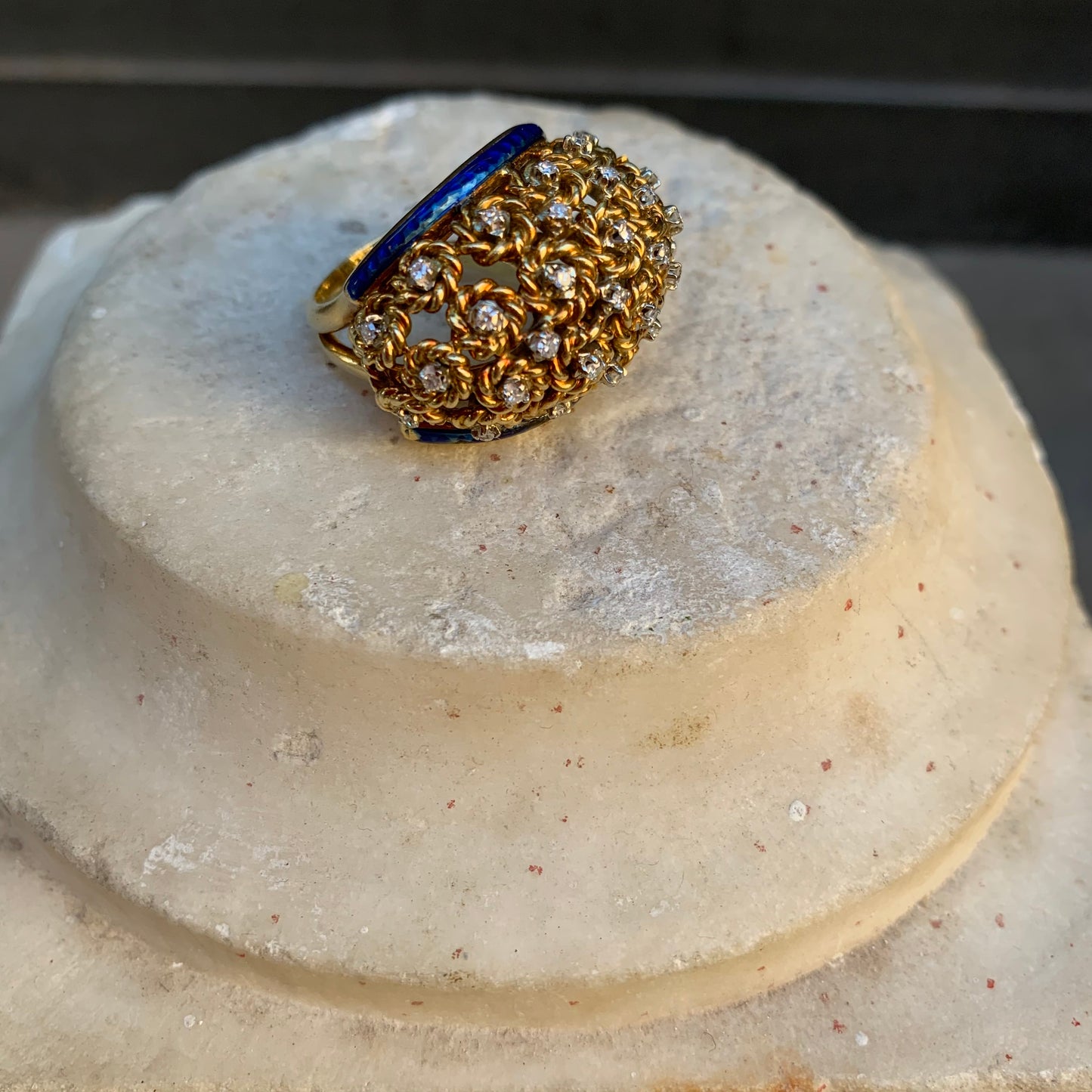 A dome ring with brilliant flowers and blue enamel.