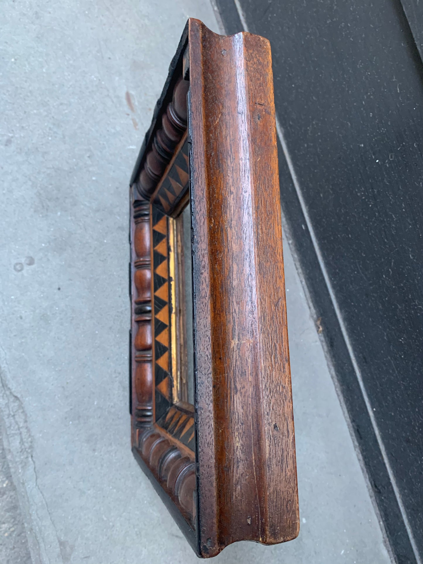 Unusual frame in various woods with geometric decorations.  Early 19 century